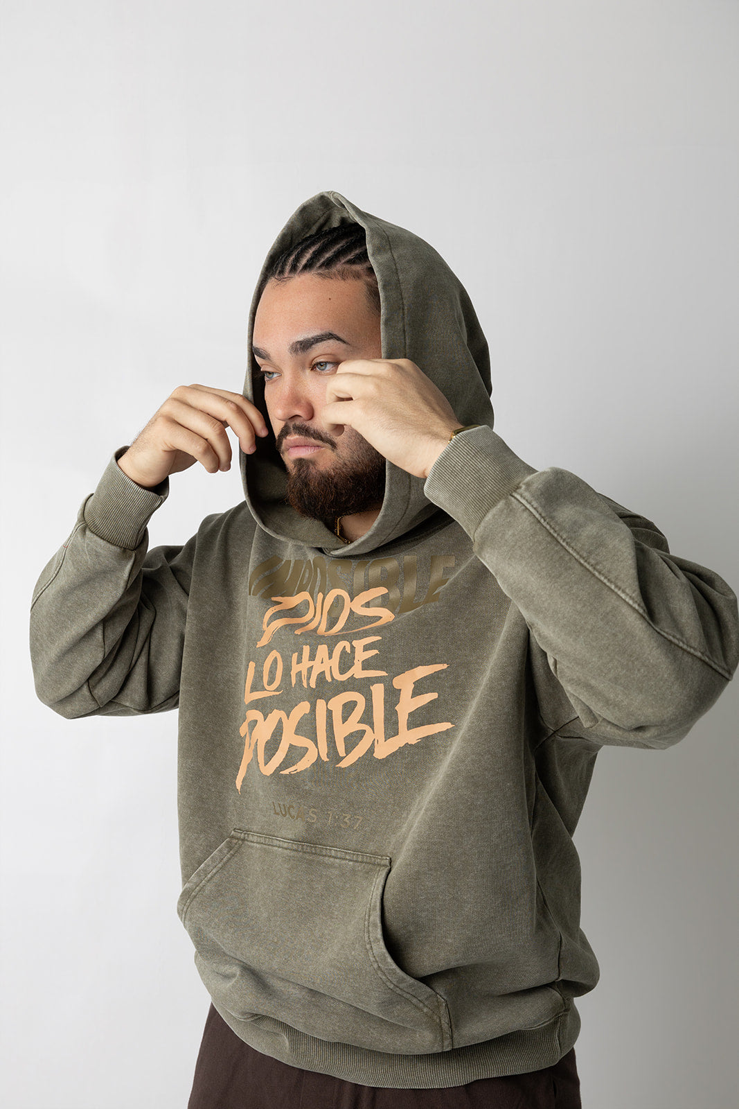 Man wearing the washed olive Lucas 1:37 Dios Lo Hace Posible Christian hoodie by Kokii Style