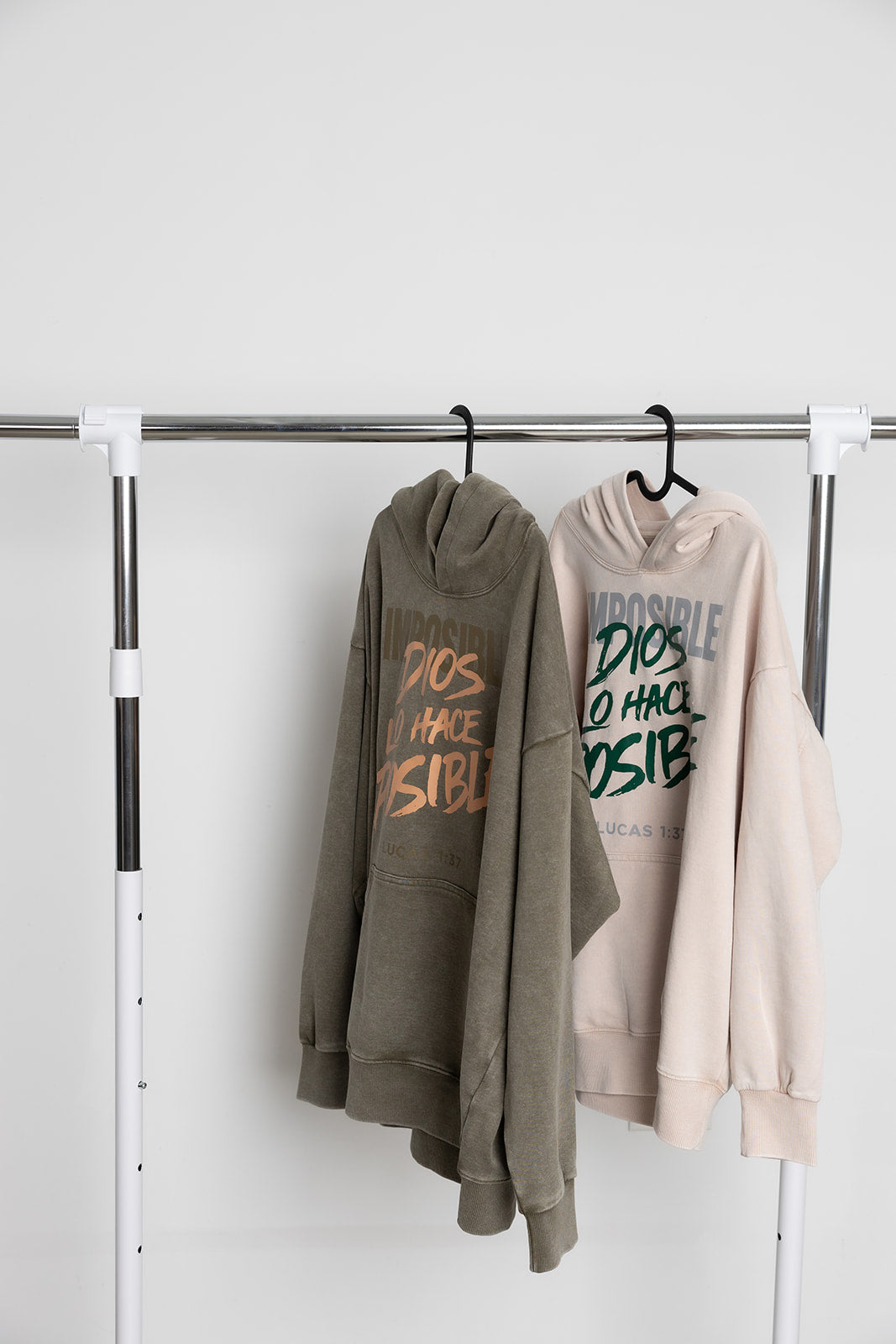 Washed olive and washed sand Dios Lo Hace Posible Christian hoodies on a clothing rack – Kokii Style