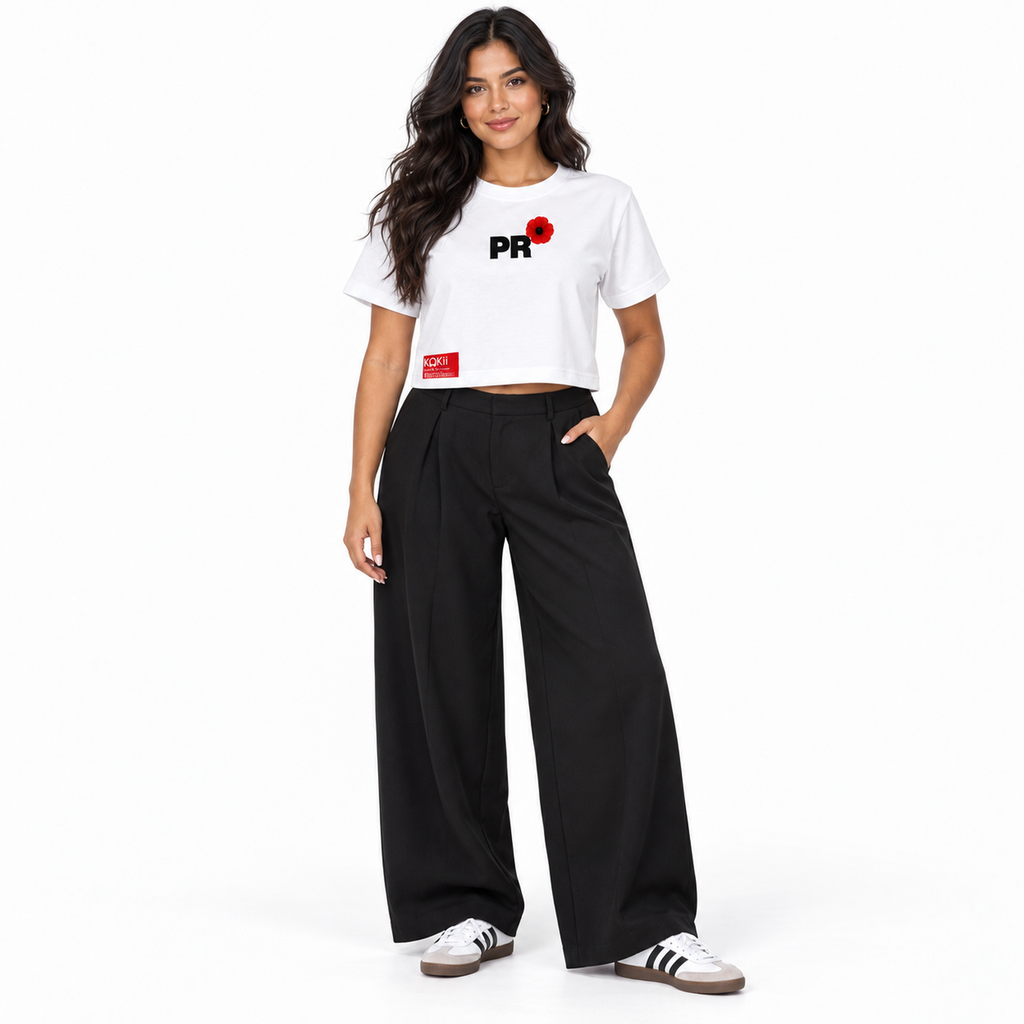 Woman wearing the Kokii Style PR Flor de Maga Crop Top in white with black wide-leg trousers and sneakers – front view, Puerto Rico streetwear